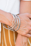 "Zesty Zimbabwe" (P9BA-SVXX-021HD)  Stamped in tribal inspired patterns, round and wavy silver bangles stack across the wrist for a seasonal look. Sold as one set of seven bracelets.