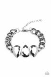 Three oversized hematite teardrop gems join at the center of a dramatic gunmetal chain, creating a jaw-dropping display across the wrist. Features an adjustable clasp closure. Sold as one individual bracelet. P9ED-BKXX-073XX