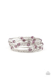 A collection of silver beads, glowing purple cat's eye stones, and studded silver accents are threaded along a coiled wire, creating a colorful infinity wrap style bracelet around the wrist. Sold as one individual bracelet. P9WH-PRXX-211XX