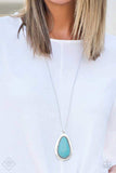 "BADLAND To The Bone" (P2SE-BLXX-334HD)  A dramatic turquoise stone teardrop is pressed into a glistening silver frame radiating with rustic patterns. The impressive pendant swings from the bottom of a lengthened silver chain for a seasonal look. Features an adjustable clasp closure. Sold as one individual necklace. Includes one pair of matching earrings.