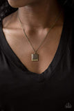A filigree filled brass frame is pressed into a larger hammered frame, creating a dainty pendant below the collar. Features an adjustable clasp closure. Sold as one individual necklace. Includes one pair of matching earrings. P2DA-BRXX-120XX