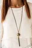 An oversized brass bead swings from the bottom of a glistening brass chain, creating a dramatic pendant. Matching brass chains stream from the bottom of the bead for a bold industrial look. Features an adjustable clasp closure. Sold as one individual necklace. Includes one pair of matching earrings. P2IN-BRXX-103XX