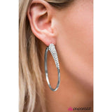 2020 Encore Piece As if dipped in glitter, a rhinestone encrusted frame swings from the ear in a dramatic fashion. Hoop measures 1 1/2” in diameter. Earring attaches to a standard post fitting. Sold as one pair of hoop earrings.  P5HO-WTXX-010XX