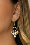 Varying in shape, opalescent white rhinestones and antiqued brass frames fan out from the bottom of a dainty brass hoop for a whimsical look. Earring attaches to a standard fishhook fitting. Sold as one pair of earrings.  P5SE-BRXX-073XX