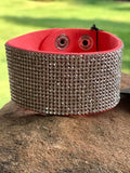 2018 August Fashion Fix Exclusive Row after row of glassy white rhinestones are encrusted along a thick orange suede band, creating knockout shimmer across the wrist. Features an adjustable snap closure.  P9DI-UROR-044XX