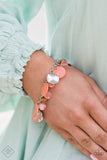 "Springtime Springs" (P9ST-OGXX-009ZZ)  Springtime charms of shiny and soft beads and pearl-like discs in lovely tones of Burnt Coral sway from a silver chain. Accents of sparkly, wavy silver discs and wooden beads bring it down to earth as the fringe wraps around the wrist. Features an adjustable clasp closure. Sold as one individual bracelet.