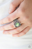 A glowing green moonstone adorns the center of a silver band swirling with whimsical floral detail for a seasonal look. Features a stretchy band for a flexible fit. Sold as one individual ring.  P4RE-GRXX-084XX
