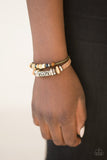 An array of glassy, wooden, and metallic beads slide along one leather strand and a rustic green cord, creating colorful layers across the wrist. Features an adjustable sliding knot closure. Sold as one individual bracelet.  P9UR-BNXX-282XX