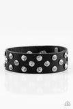 Encased in shimmery silver frames, glittery white rhinestones are sprinkled along a shiny black leather band for a dramatic look. Features an adjustable snap closure. Sold as one individual bracelet.  P9DI-URBK-124XX