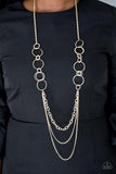 Smooth and shimmery textured hoops give way to layers of mismatched brass chains for a classic look. Features an adjustable clasp closure. Sold as one individual necklace. Includes one pair of matching earrings.  P2IN-BSXX-179XX