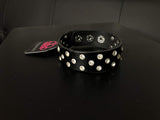 Encased in shimmery silver frames, glittery white rhinestones are sprinkled along a shiny black leather band for a dramatic look. Features an adjustable snap closure. Sold as one individual bracelet.  P9DI-URBK-124XX