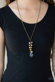 A collection of white pearls, shiny brass beads, and glassy white teardrops trickle along an extended chain that swings from the bottom of a classic brass chain. An oversized teardrop swings from the bottom of the extension, creating a whimsical pendant. Features an adjustable clasp closure. Sold as one individual necklace. Includes one pair of matching earrings.  P2WH-BRXX-155XX
