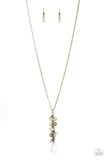 A collection of white pearls, shiny brass beads, and glassy white teardrops trickle along an extended chain that swings from the bottom of a classic brass chain. An oversized teardrop swings from the bottom of the extension, creating a whimsical pendant. Features an adjustable clasp closure. Sold as one individual necklace. Includes one pair of matching earrings.  P2WH-BRXX-155XX