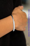 The center of a dainty silver cuff is encrusted in row after row of glassy white rhinestones for a timeless look. Sold as one individual bracelet. P9RE-WTXX-189XX