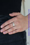 A dainty white pearl is pressed into an abstract white rhinestone encrusted band for a timeless twist. Features a dainty stretchy band for a flexible fit. Sold as one individual ring.  P4DA-WTXX-085XX