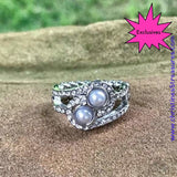 2020 March Fashion Fix Exclusive Glittery white rhinestone encrusted bands swirl around a pair of silver pearls for a refined look. Features a dainty stretchy band for a flexible fit. Sold as one individual ring. P4RE-SVXX-137XX