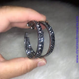 BLOCKBUSTER PIECE The front facing surface of a chunky gunmetal hoop is dipped in brilliantly sparkling hematite rhinestones while light-catching texture wraps around the back. The interior of the hoop features the opposite pattern, creating the illusion of a full hoop of blinding shimmer. Earring attaches to a standard post fitting. Hoop measures 1 3/4" in diameter. Sold as one pair of hoop earrings. P5HO-BKXX-001XX