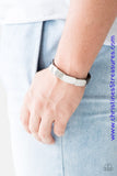 Overlapping silver frames are studded in place across a skinny brown leather band for a rugged look Features an adjustable snap closure. Sold as one individual bracelet.  P9UR-BNXX-395XX
