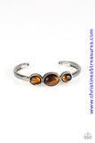 Glowing Tiger's Eye stones are encrusted across the middle of a dainty silver cuff for a seasonal flair. As the stone elements in this piece are natural, some color variation is normal. Sold as one individual bracelet.  P9SE-BNXX-116XX