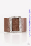 Two rows of dazzling white rhinestones coalesce into a rectangular frame. The glittery frame is threaded along a band of brown leather, creating a stunning centerpiece. Features an adjustable snap closure. Sold as one individual bracelet.  P9DI-URBN-032XX