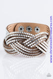 Oversized glassy white rhinestones are encrusted along strands of crisscrossing brown suede, creating a fierce shimmer around the wrist. Features an adjustable snap closure. Sold as one individual bracelet.  P9DI-URBN-045XX