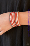 Shiny silver studs and rows of smoky and glittery white rhinestones are encrusted along strips of orange suede, creating sassy shimmer around the wrist. Features an adjustable snap closure. Sold as one individual bracelet.  P9DI-UROG-025XX