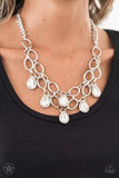 BLOCKBUSTER PIECE Joined by dainty silver links, two rows of dramatic silver chain layer below the collar in a fierce fashion. Glittery white teardrops drip from the glistening layers, adding a timeless shimmer to the show-stopping piece. Features an adjustable clasp closure. Sold as one individual necklace. Includes one pair of matching earrings.  P2RE-WTXX-178XX
