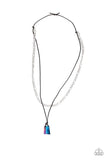Featuring an oil slick finish, a metallic chunk of blue rock swings from the bottom of a black cord. A strand of silver chain is added for an edgy urban look. Features an adjustable sliding knot closure. Shape/size may vary. Sold as one individual necklace. ***Please note: This is an urban necklace so earrings DO NOT come with this necklace ***   P2MN-URBL-004XX