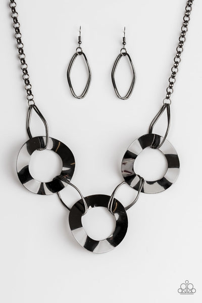 2018 Convention Exclusive Featuring slightly warped surfaces, asymmetrical gunmetal hoops link with reflective gunmetal rings below the collar for a modern look. Features an adjustable clasp closure. Sold as one individual necklace. Includes one pair of matching earrings.  P2IN-BKXX-142XX