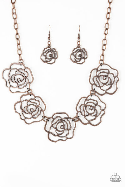 Brushed in an antiqued finish, stenciled copper rosebuds link below the collar for a seasonal fashion. Features an adjustable clasp closure. Sold as one individual necklace. Includes one pair of matching earrings.  P2WH-CPXX-146XX