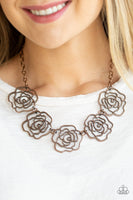 Brushed in an antiqued finish, stenciled copper rosebuds link below the collar for a seasonal fashion. Features an adjustable clasp closure. Sold as one individual necklace. Includes one pair of matching earrings.  P2WH-CPXX-146XX