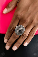 Ring: "Castle Lockdown" (P4RE-SVXX-138OY)  An oversized hematite gem is pressed into a round silver frame encrusted in stacked rings of smoky rhinestones in a regal finish. Features a stretchy band for a flexible fit. Sold as one individual ring.