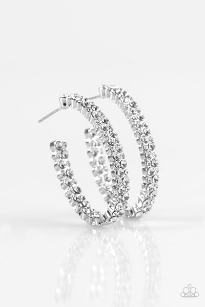 The front of a shimmery silver hoop is encrusted in rows of glassy white rhinestones for a glamorous look. Earring attaches to a standard post fitting. Hoop measures 1” in diameter. Sold as one pair of hoop earrings. P5HO-WTXX-038XX