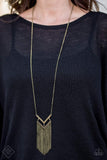 2018 August Fashion Fix Encrusted in aurum rhinestones, a V-shaped frame attaches to an airy brass frame, creating a stacked pendant. Swinging from the bottom of a lengthened brass chain, the glamorous pendant gives way to a tapered fringe for a fierce finish. Features an adjustable clasp closure. Sold as one individual necklace. Includes one pair of matching earrings. P2ED-BRXX-080GO