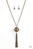 An oversized brass bead swings from the bottom of a glistening brass chain, creating a dramatic pendant. Matching brass chains stream from the bottom of the bead for a bold industrial look. Features an adjustable clasp closure. Sold as one individual necklace. Includes one pair of matching earrings. P2IN-BRXX-103XX