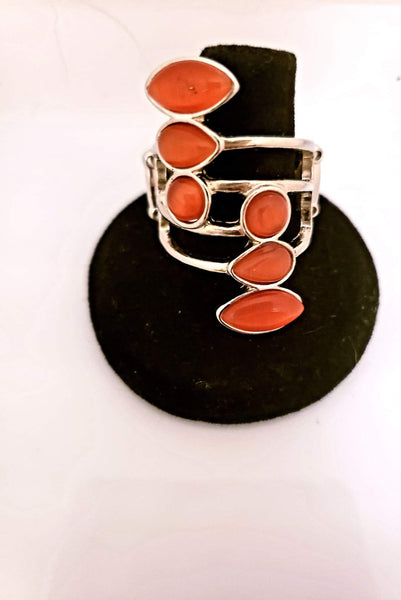 2019 December Fashion Fix Exclusive Featuring round, teardrop, and marquise shapes, two frames of glowing orange cat's eye stones stack across a layered silver band for an all around radiance. Features a stretchy band for a flexible fit. Sold as one individual ring.  P4WH-OGXX-109RG