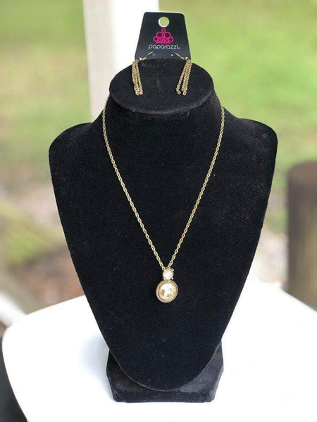 Varying in size and cut, aurum rhinestones are pressed into shimmery brass frames, creating a glamorous pendant below the collar. Features an adjustable clasp closure. Sold as one individual necklace. Includes one pair of matching earrings.  P2RE-BSXX-142XX
