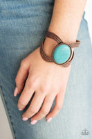 A dramatic turquoise stone pendant is pressed into the center of textured copper bars, creating a bold seasonal cuff. Sold as one individual bracelet.  P9SE-CPXX-057XX