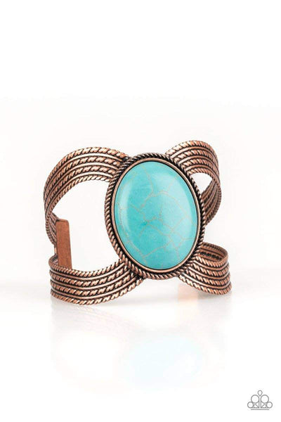 A dramatic turquoise stone pendant is pressed into the center of textured copper bars, creating a bold seasonal cuff. Sold as one individual bracelet.  P9SE-CPXX-057XX