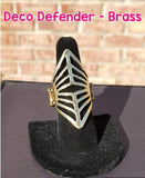 2020 January Fashion Fix Exclusive A glistening diamond-shaped brass frame in an art deco pattern folds around the finger for an edgy, geometric look. Features a stretchy band for a flexible fit.  P4ED-BRXX-070RV