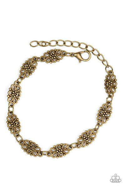 Brushed in an antiqued shimmer, dainty floral charms link across the wrist for a seasonal look. Features an adjustable clasp closure. Sold as one individual bracelet.  Get The Complete Look! Necklace: "Daisy Dream - Brass" (Sold Separately)  P9WH-BRXX-095WB