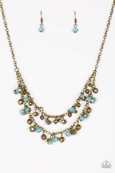Faceted brass and metallic blue crystal-like beads swing from the bottoms of shimmery brass chains, creating a fierce fringe below the collar. Features an adjustable clasp closure. Sold as one individual necklace. Includes one pair of matching earrings.  P2RE-BRBL-111TS