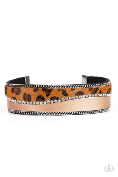 2019 October Life Of The Party Infused with strands of antiqued silver chains and glassy white rhinestones, wavy pieces of tan leather and cheetah print line the front of a black suede band for a fierce look. Features an adjustable clasp closure. Sold as one individual bracelet.  P9DI-URBN-092XX