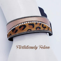 2019 October Life Of The Party Infused with strands of antiqued silver chains and glassy white rhinestones, wavy pieces of tan leather and cheetah print line the front of a black suede band for a fierce look. Features an adjustable clasp closure. Sold as one individual bracelet.  P9DI-URBN-092XX