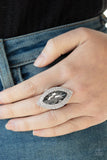 Featuring a smoky finish, a dramatic gem is pressed into the center of stacking silver frames encrusted in row after row of glassy white rhinestones for a blinding look. Features a stretchy band for a flexible fit. Sold as one individual ring.  P4RE-SVXX-153XX