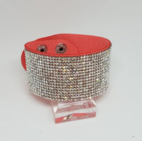 2018 August Fashion Fix Exclusive Row after row of glassy white rhinestones are encrusted along a thick orange suede band, creating knockout shimmer across the wrist. Features an adjustable snap closure.  P9DI-UROR-044XX