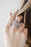 Shimmery silver frames, glassy white rhinestones, and glowing purple moonstones coalesce across the finger, creating a bubbly frame. Features a stretchy band for a flexible fit. Sold as one individual ring.  P4RE-PRXX-097XX