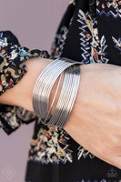 Bracelet: "Urban Glam" (P9BA-SVXX-038HU) Threaded along two metallic rods, glistening silver bands crisscross across the wrist, creating the illusion of countless silver bangles in the convenience of a simple layered cuff. Sold as one individual bracelet.