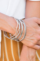 2018 October Fashion Fix - Simply Santa Fe  Stamped in tribal inspired patterns, round and wavy silver bangles stack across the wrist for a seasonal look. Sold as one set of seven bracelets.  P9BA-SVXX-021HD