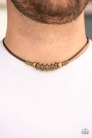 Stamped in tribal inspired patterns, antiqued brass accents and mismatched brass beads slide along a brown cord, creating an urban look below the collar. Features a button loop closure. Sold as one individual necklace. P2UR-BRXX-023XX
